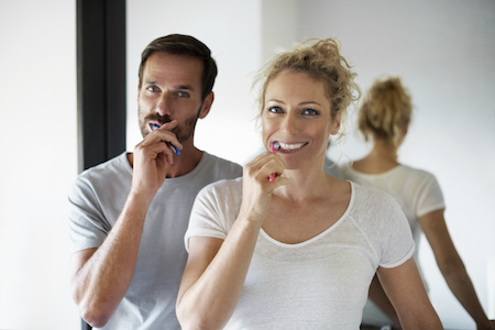 couple brushing their teeth together